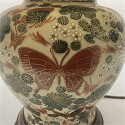 Japanese ceramic table lamp, decorated with flowers and butterflies upon a circular wooden base, with shades H52cm