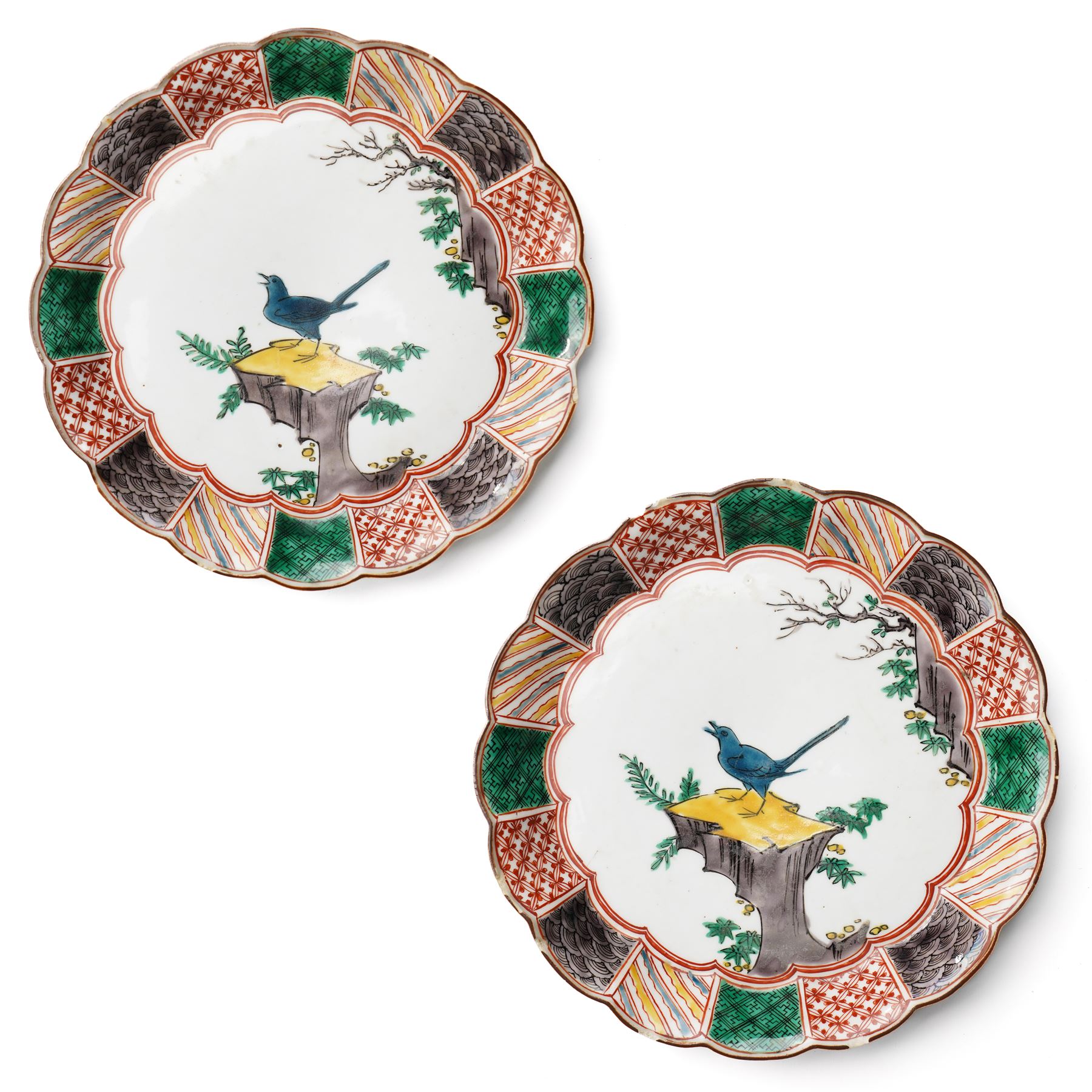 Pair of Japanese Edo period Ko Kutani dishes, decorated in green, yellow, blue iron-red, and aubergine enamels, the centres painted with a singing bird perched on a rock among foliage, within a border of alternating geometric designs and a chocolate-brown rim, the reverse with underglaze blue foliage, Fuku mark, D20.8cm (2) A matching pair of dishes is held in the collection of the Cleveland Museum of Art (see accession no. 1964.262)