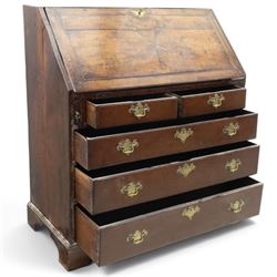 18th century inlaid oak bureau, the fall-front with central star inlay enclosing fitted interior with central cupboard flanked by fluted column correspondence drawers and pigeon holes, over two short and three long drawers, lower moulded edge on bracket feet