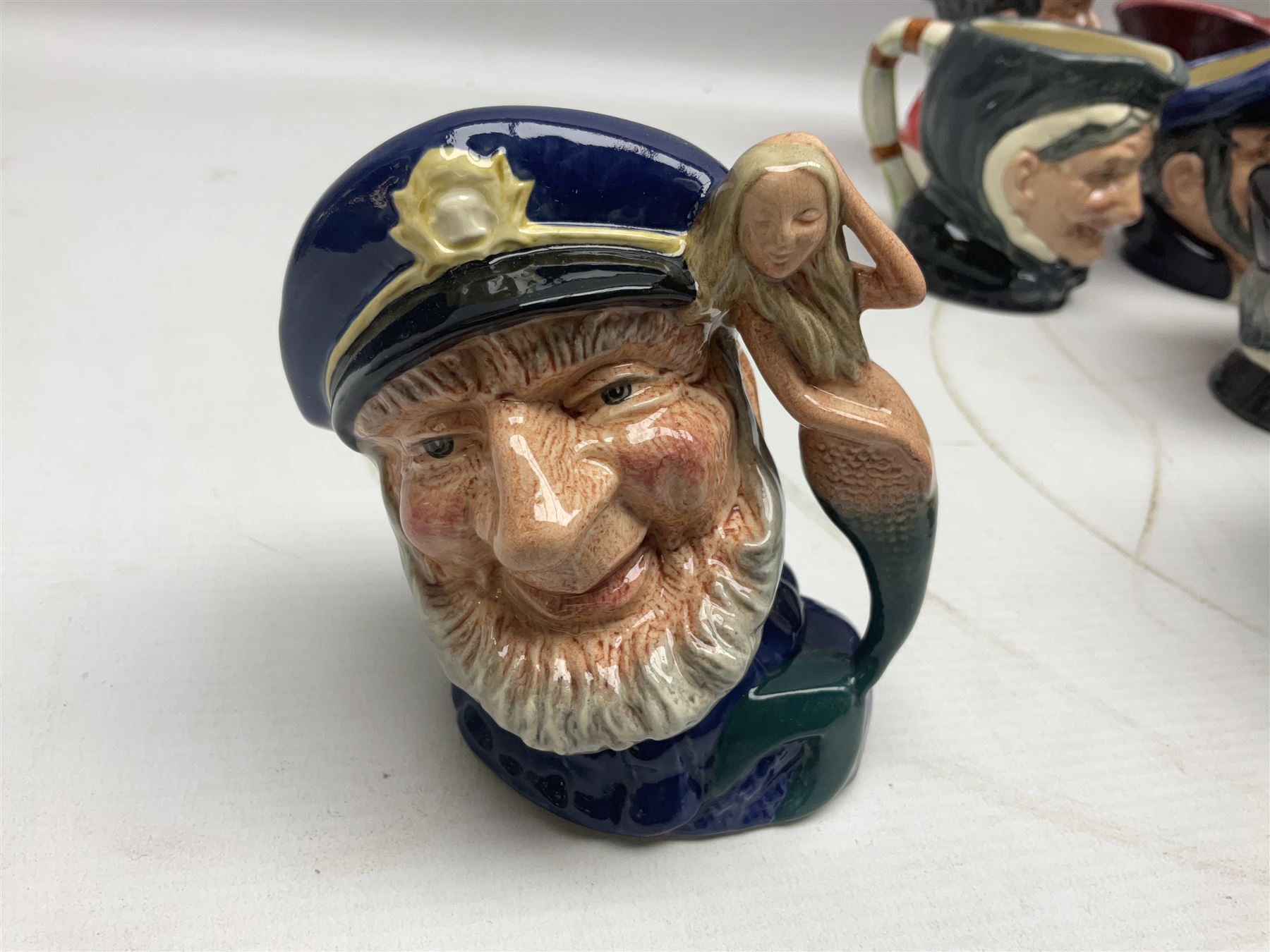 Large collection of Royal Doulton miniature character jugs, to include The Postman D6801, The London 'Bobby' D6762, Old Salt, D6554, Sir Henry Doulton D6703 etc  