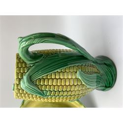 A Victorian majolica bread plate depicting corn within a woven basket, L33cm, together with a Victorian majolica jug modelled in the form of a corn cob, with registration mark beneath, H22cm. 