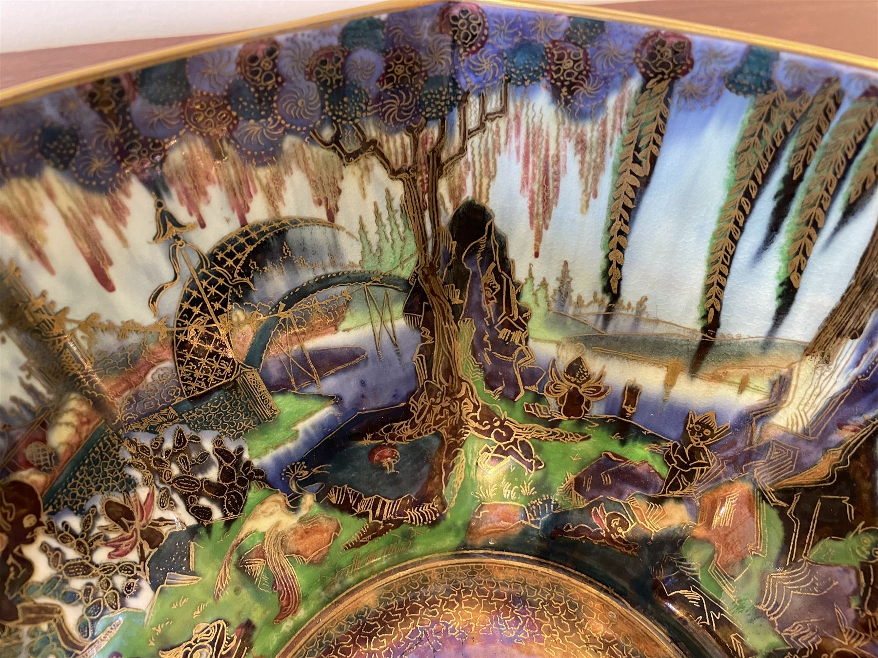 Early 20th century Wedgwood Fairland lustre bowl, circa 1920, of octagonal form, designed by Daisy Makeig-Jones, the exterior decorated in the Castle on the Road pattern, the interior decorated in the Fairy in a Cage pattern, pattern no Z5125, with printed marks beneath, H11cm D22.5cm
