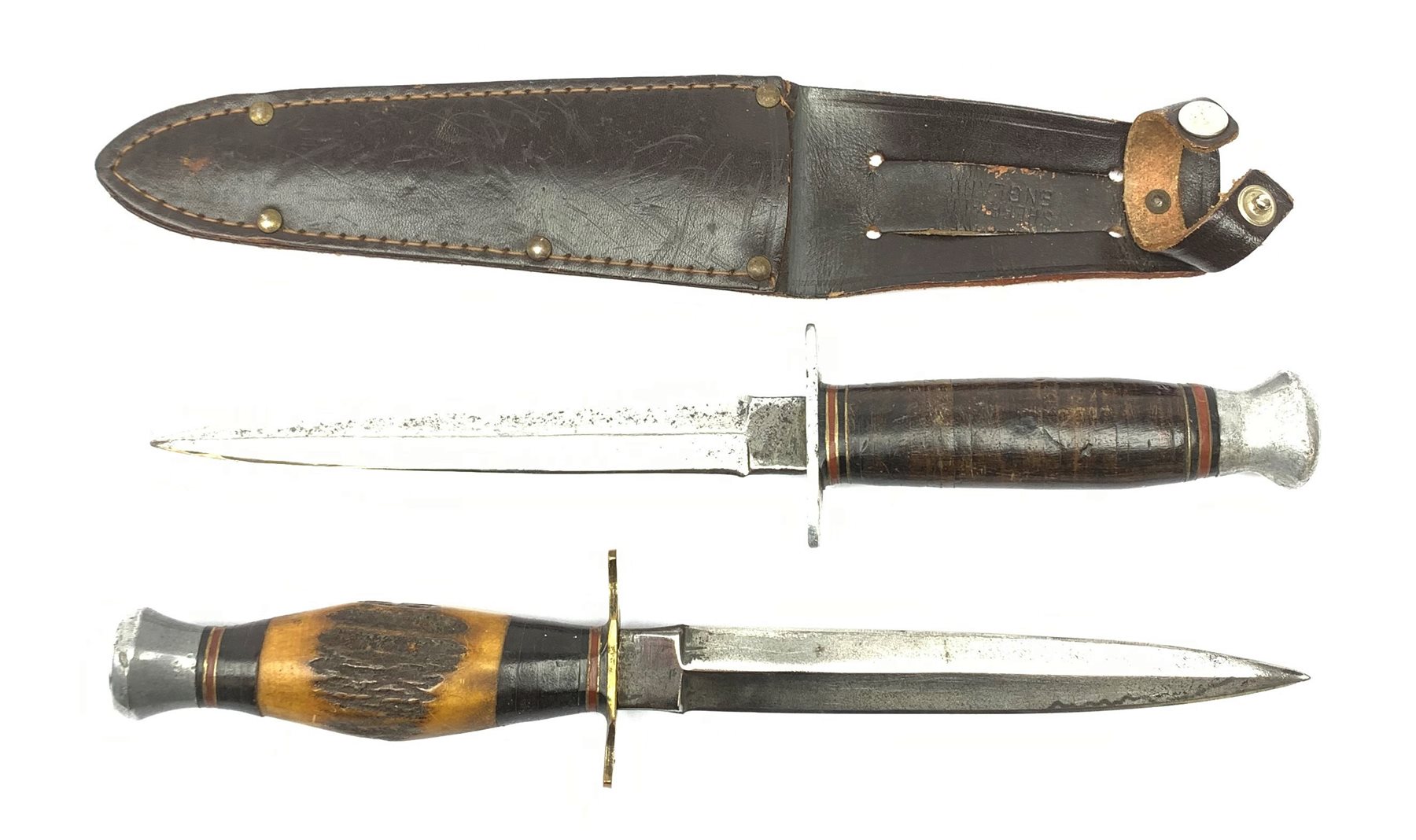 American WW2 type fighting knife with 15cm steel double edged blade, aluminium crosspiece and pommel and leather bound grip, in leather sheath marked Sheffield England L27cm overall; and another similar fighting knife with antler grip and no sheath (2)