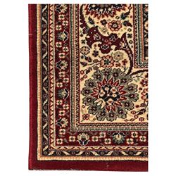 Royal Kashmir worsted wool modern Persian design area rug, with crimson field and stylised rosette patterning throughout, surrounded by wide multi-band border incorporating cartouche and lotus flower motifs
