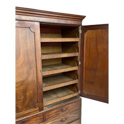 George III mahogany linen press, projecting cornice over two figured doors enclosing five linen slides, the lower section fitted with two short and two long drawers, on bracket feet
