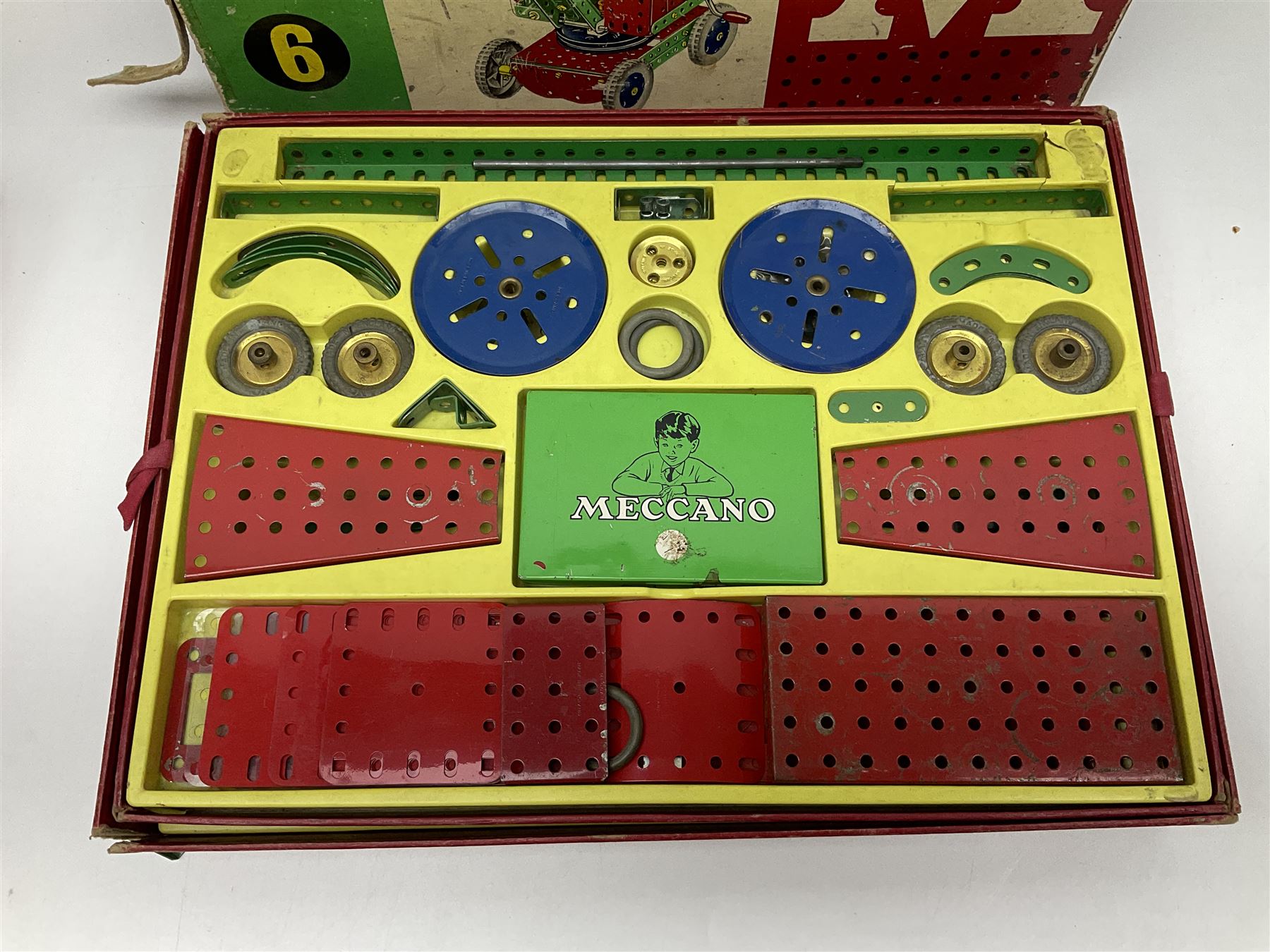 Meccano - Outfits 4, 6 & 7 with red and green parts; Outfits 4 & 6 virtually fully stocked and Outfit 7 containing large quantity of loose parts; Outfits 4 & 7 with instruction manuals; all boxed (3)