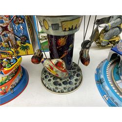 Mid 20th century and later tin plate clockwork toys, to include merry-go-rounds, spaceship carousel, walking robot, Schylling airport control tower, monkey riding horse, astronaut space station etc, including German and Japanese examples, some with boxes (12)