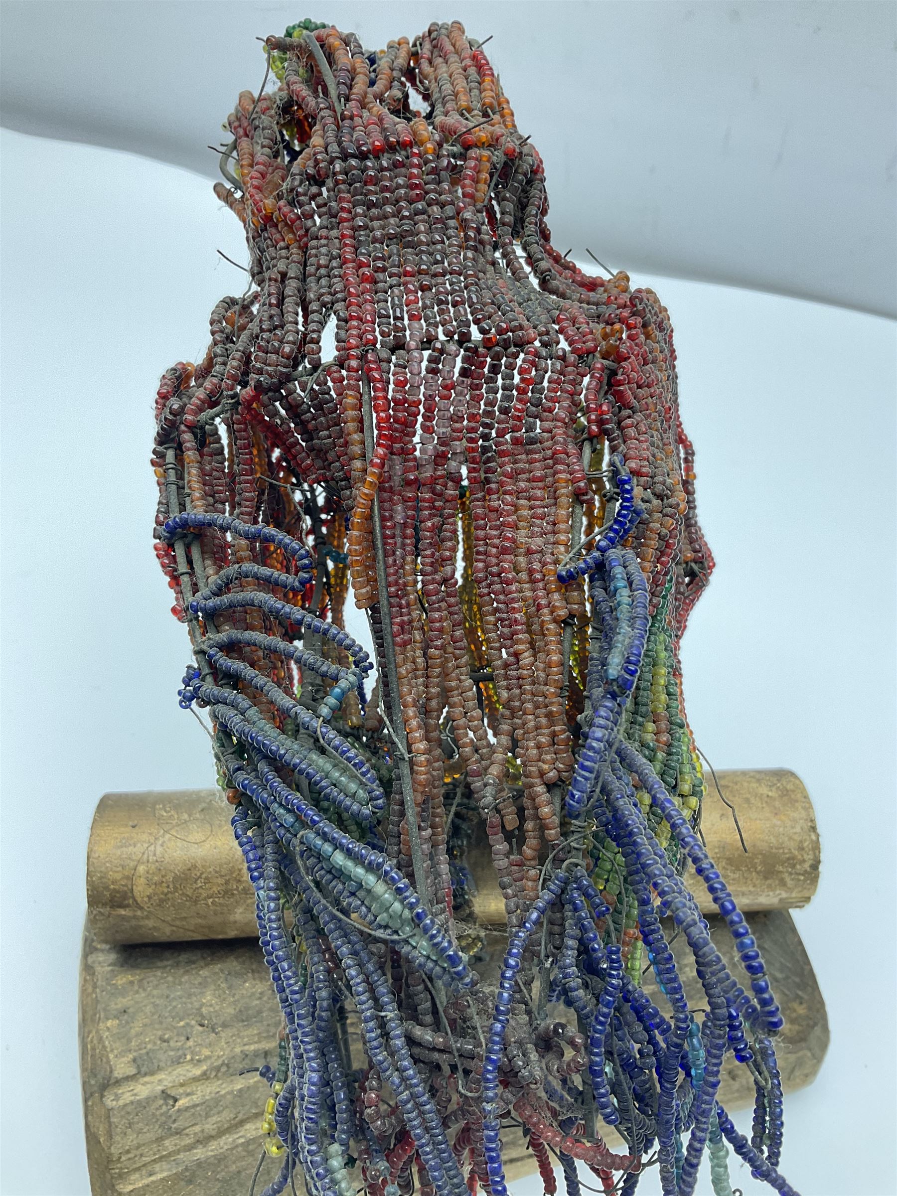 Victorian bead and wire model of a parrot, of polychrome beads, with glass eyes, on a wooden base, H24cm