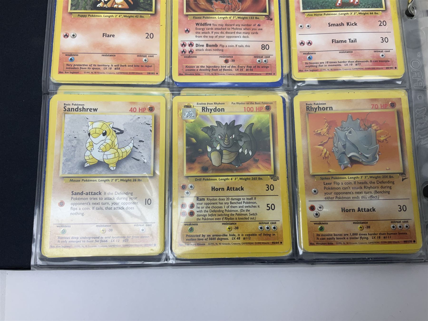 Collection of Pokemon trading cards, mostly 1999 Wizards Pokemon cards to include holo Charizard 4/102, first edition holo Machamp 8/102, further holographic cards; Dark Flareon 35/82 and Dark Vaporeon 45/82, cards from themed sets and 4th edition prints; 1998 Electronic Pokédex with cardboard boxes for themed decks Blackout, Overgrowth and Power Reserve Jungle, along with a large quantity of energy and trainer cards 