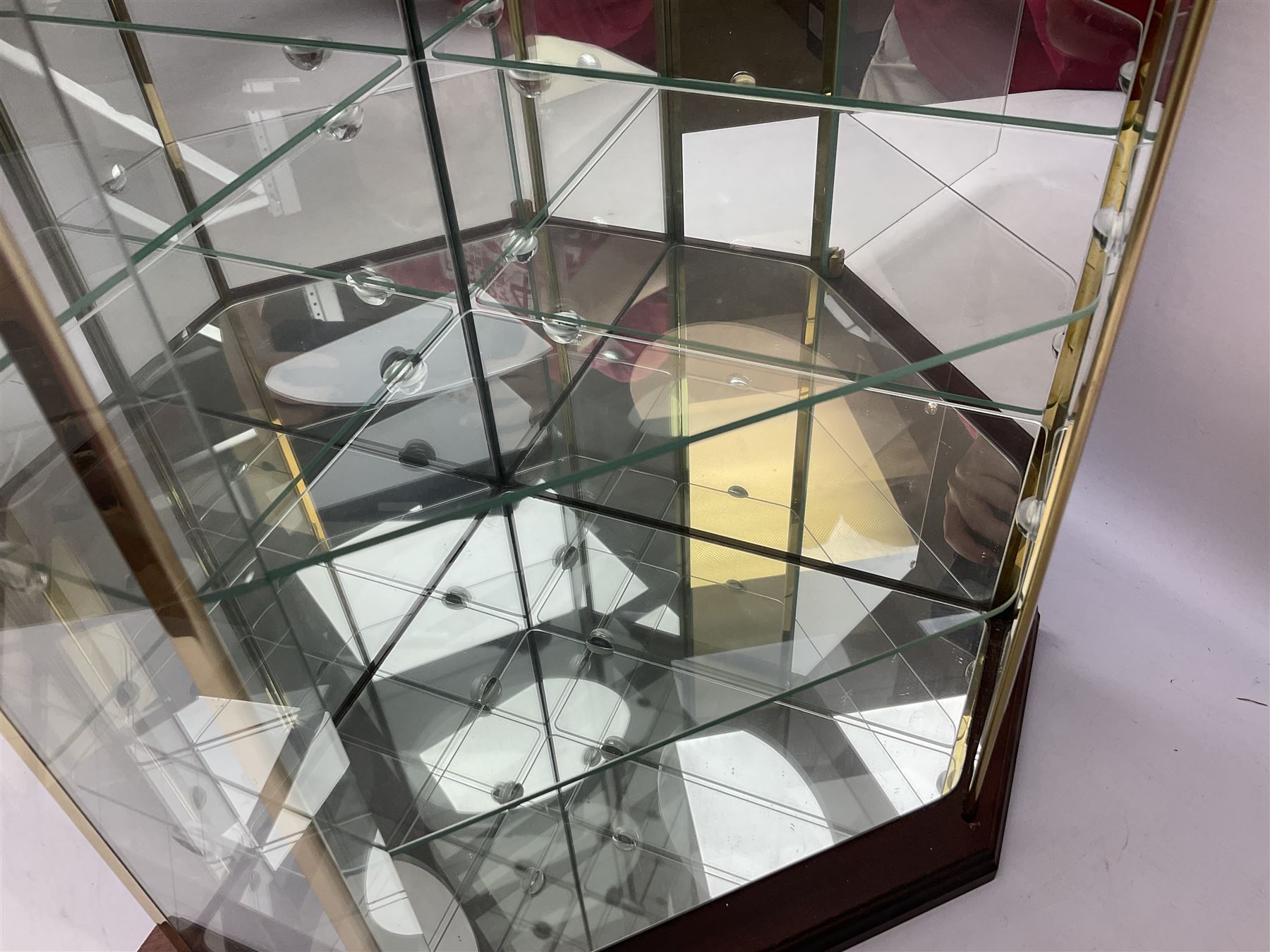 Swarovski Crystal Masquerade trilogy; 1999 Masquerade Pierrot, 2000 Columbine, 2001 Harlequin all with accompanying plaque, stand and original box, together with a glass display case with mirrored back and sides 