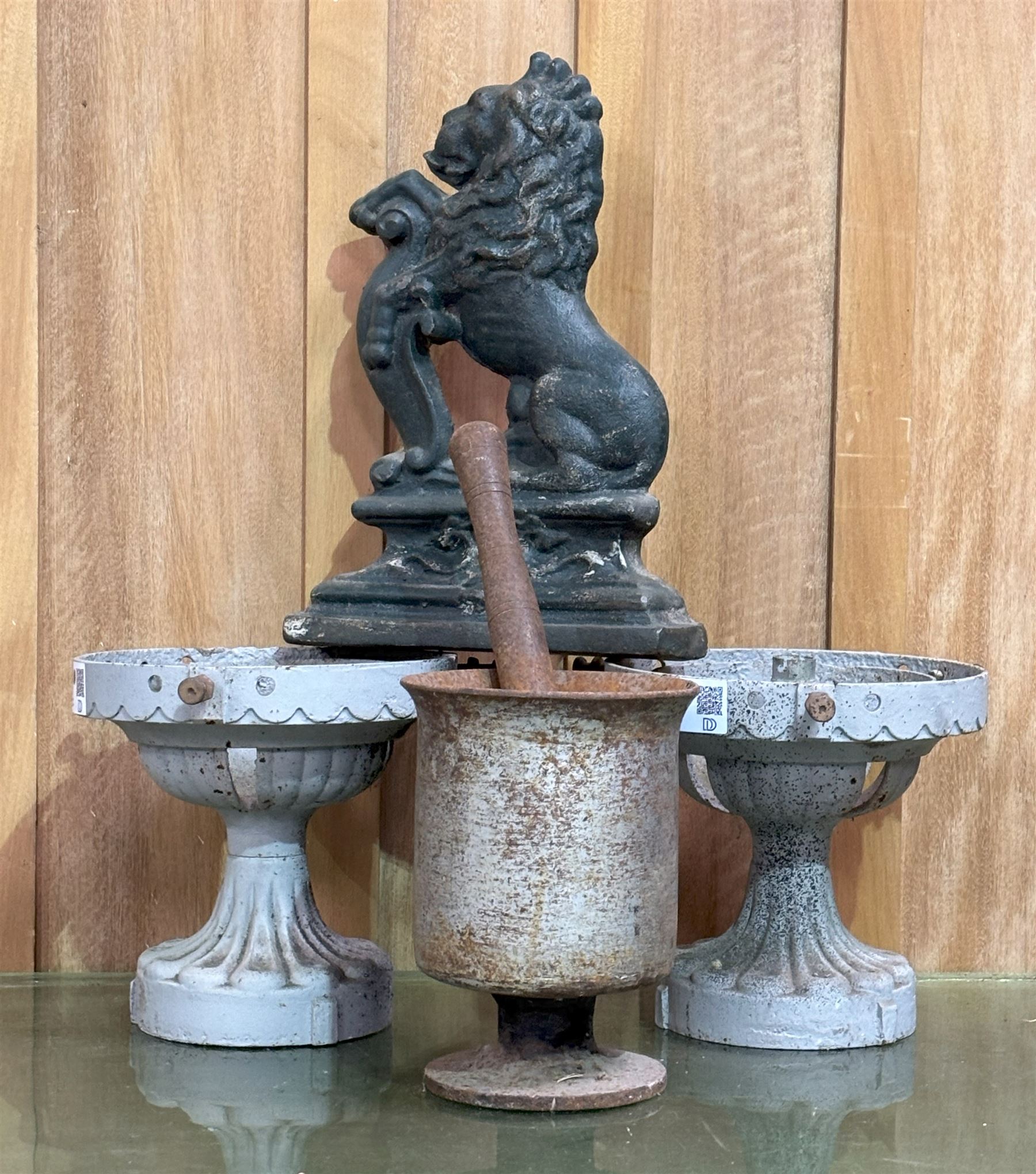 Pair of cast iron lamp bases of urn form, first half of the 20th century (H21cm) together with a cast iron door stop in the form of a heraldic lion, (H36cm) and a cast iron pestle and mortar (H21cm) (4) - COLLECTION BY APPOINTMENT FROM: The White House, Thirsk Road, Easingwold, York, YO61 3NF - CALL 01723 507111 TO ARRANGE