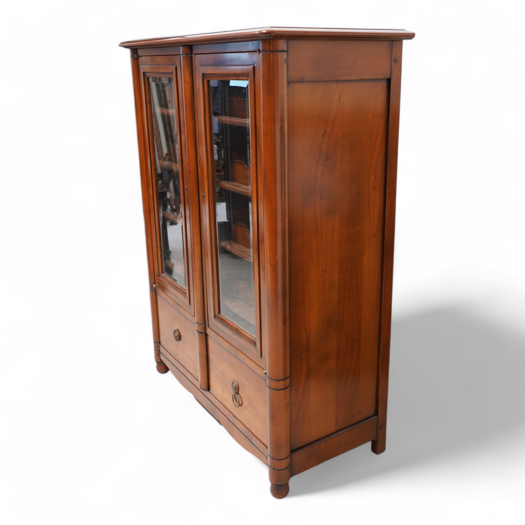 Cherrywood wine rack cabinet, moulded rectangular top over two glazed doors, fitted with eight slides each with three bottle holders inscribed with various wine types, single long drawer to the base 