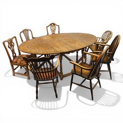 George III oak drop-leaf oval dining table with harlequin set of seven 18th century and la...
