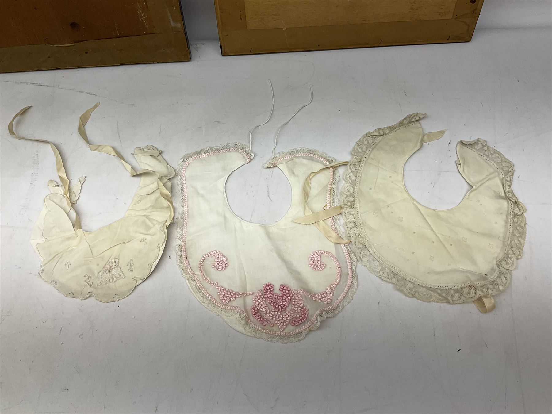 Late 18th century sampler worked with the alphabet above verses in red, by Mary Birkett aged 10 November 16th 1792, H33.5cm W34.5cm, together with another sampler worked with the alphabet above Proverbs 14:23, by Mary Anne Hainworth, Chesham, date unknown (--83), both in glazed frames, together with a quantity of Victorian and later dolls clothes to include lace examples