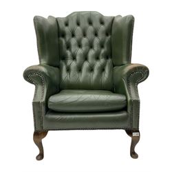 Georgian style wing back armchair, upholstered in deeply buttoned green hide, studded detail