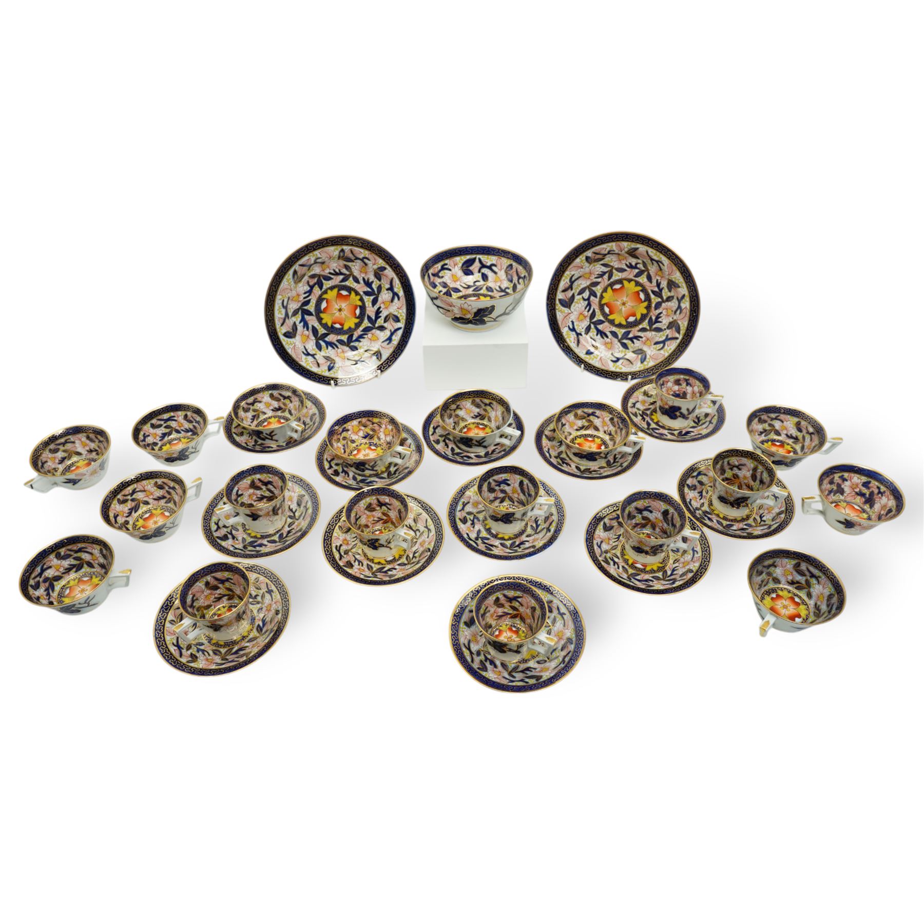 English porcelain Imari tea and coffee wares, pattern 1277, decorated with central orange floral motif surrounded by sprigs of yellow foliage within blue borders, comprising eleven teacups, eight coffee cups, twelve saucers, two shallow bowls and one finger bowl