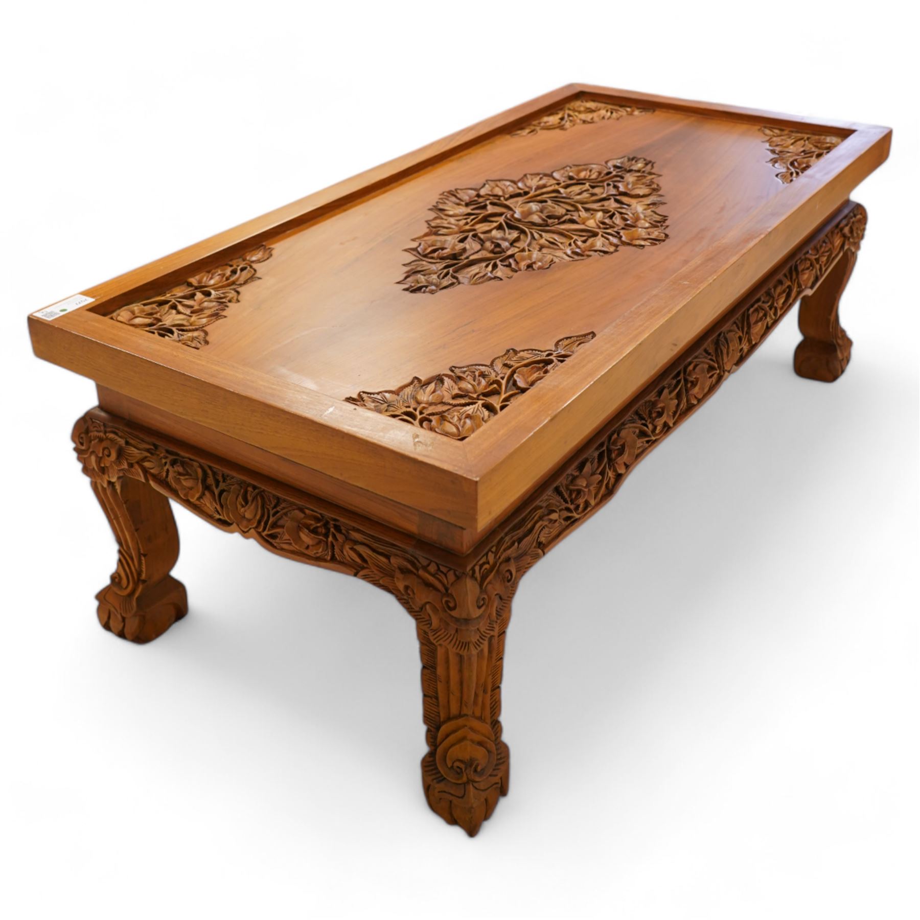 Hardwood rectangular coffee table, carved with trailing branches with foliage and flower heads, on scroll carved cabriole feet 