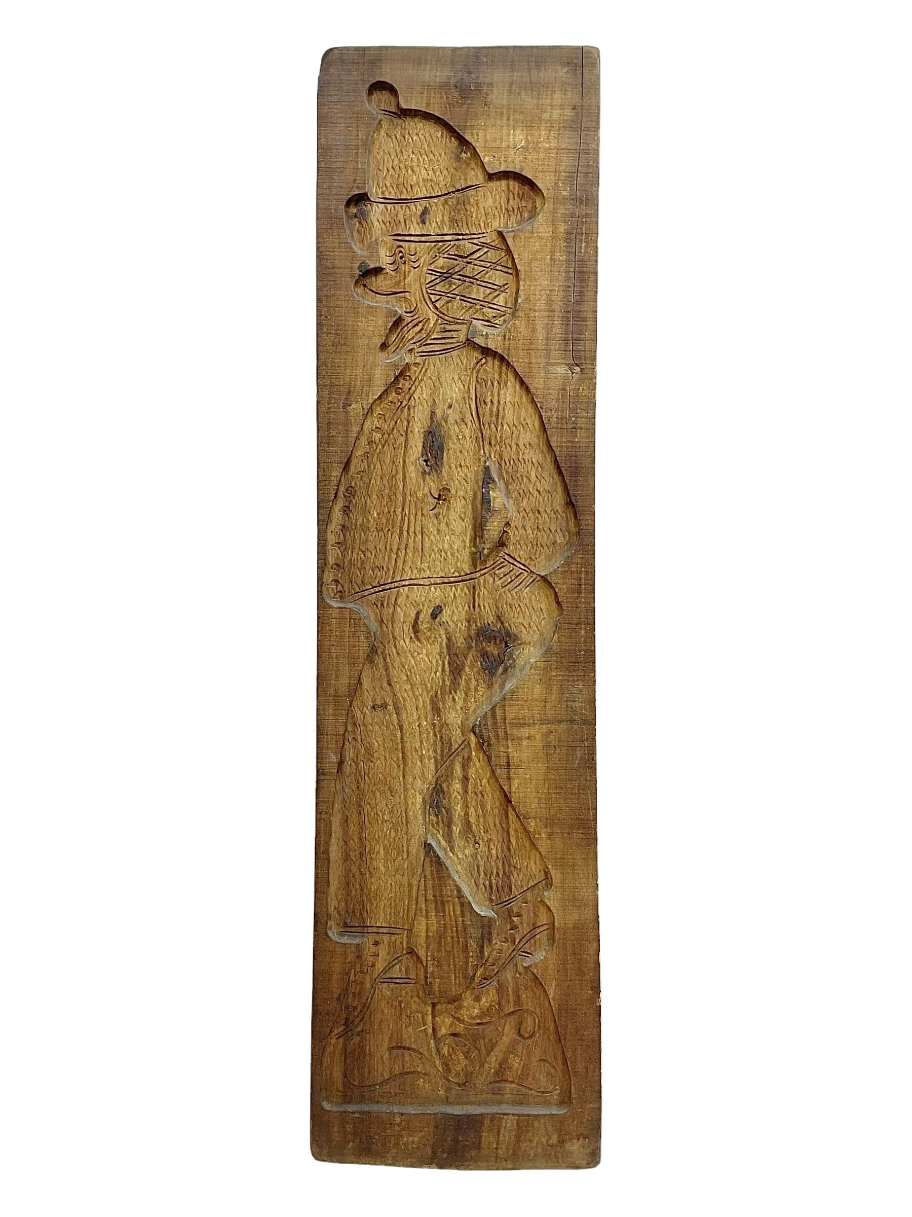 20th century hardwood Dutch folk art Speculaasplank or biscuit mould, typically carved with figure in traditional dress, H132cm