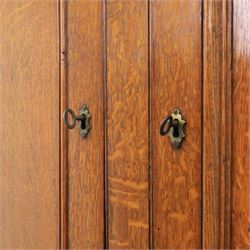 Late 19th century country oak cupboard on chest, cornice top above twin recessed panel doors with central escutcheons, flanked by turned pilasters, the lower chest with two short and three long drawers fitted with turned knob handles, on turned feet