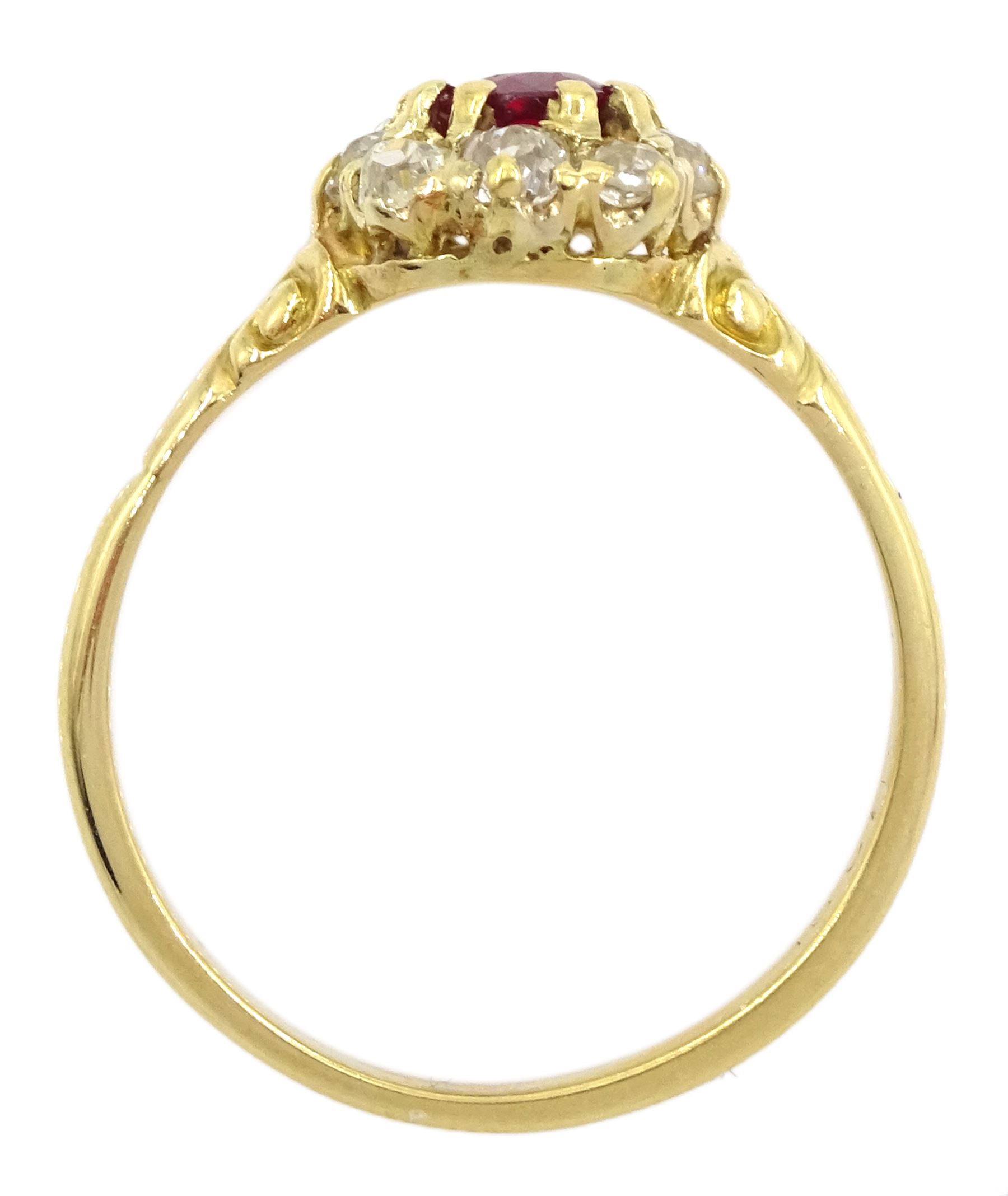Early 20th century 18ct gold oval cut ruby and old cut diamond cluster ring, stamped, ruby approx 0.45 carat, total diamond weight approx 0.35 carat