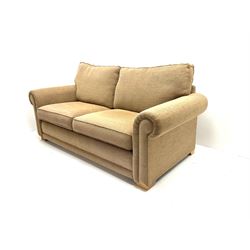 Two seat sofa bed, upholstered in ochre coloured fabric, block supports 