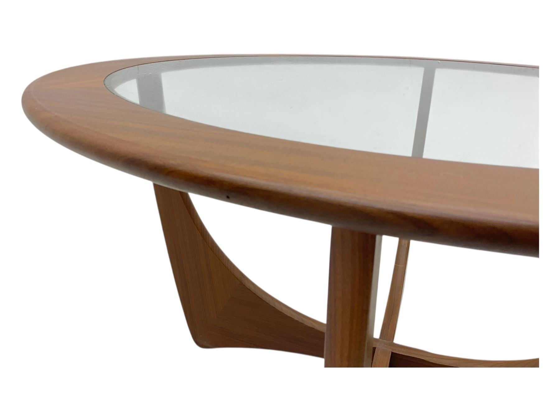 G Plan - Mid-century teak coffee table, circular form with inset glass top within a wide chamfered teak border, on sculptural cruciform base with curved intersecting supports