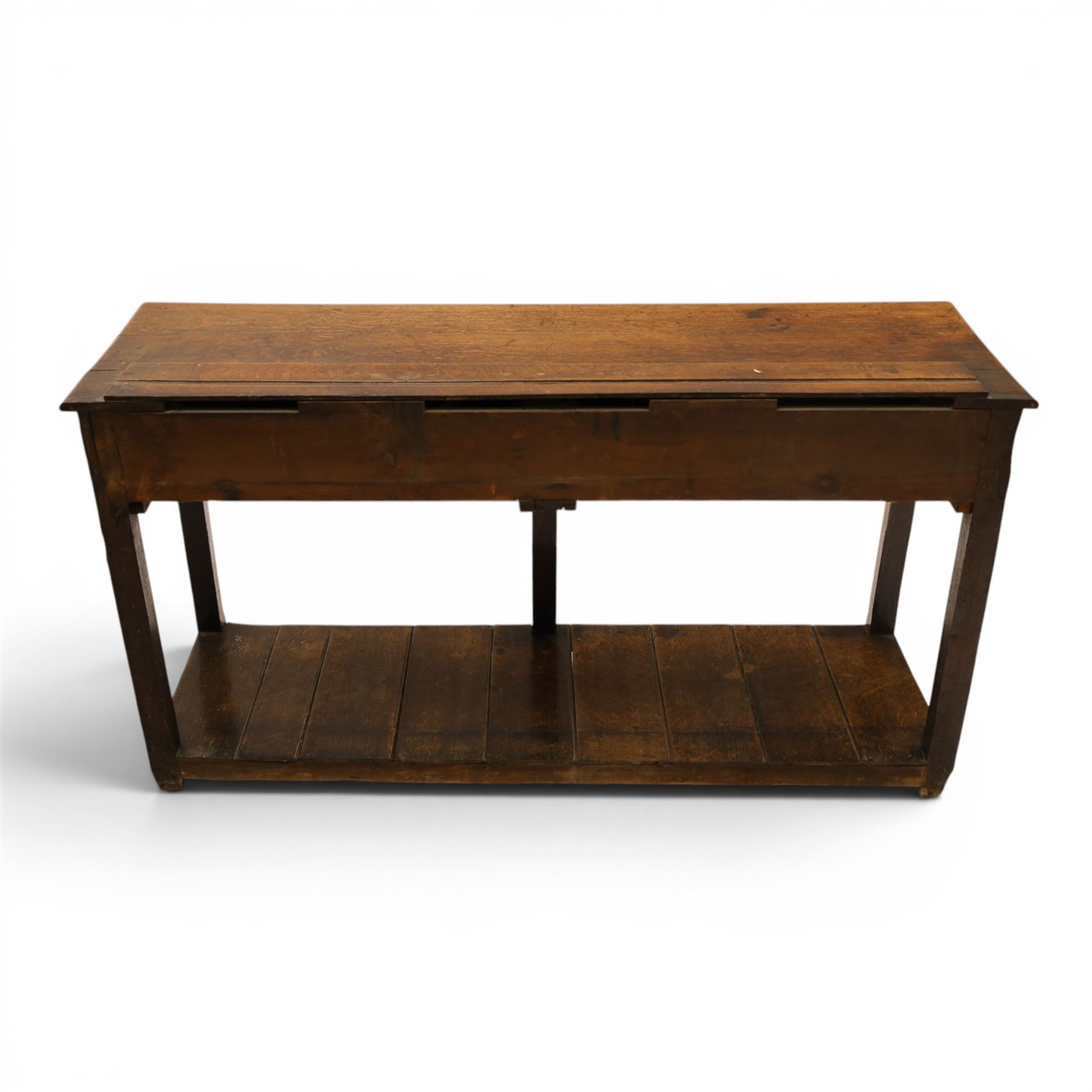 George III oak dresser base, rectangular top with moulded edge, fitted with two drawers over shaped spandrels, raised on square chamfered supports united by undertier, on stile feet