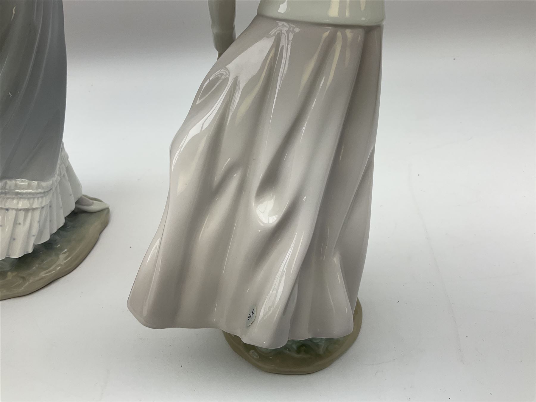 Three Lladro figures, comprising, Dreams of Summer Past no 6401, Spring Breeze no 4936 and Breezy Afternoon 5682 together with Lladro plaque Art Brings us Together no 7677, all in original boxes, largest example H35cm