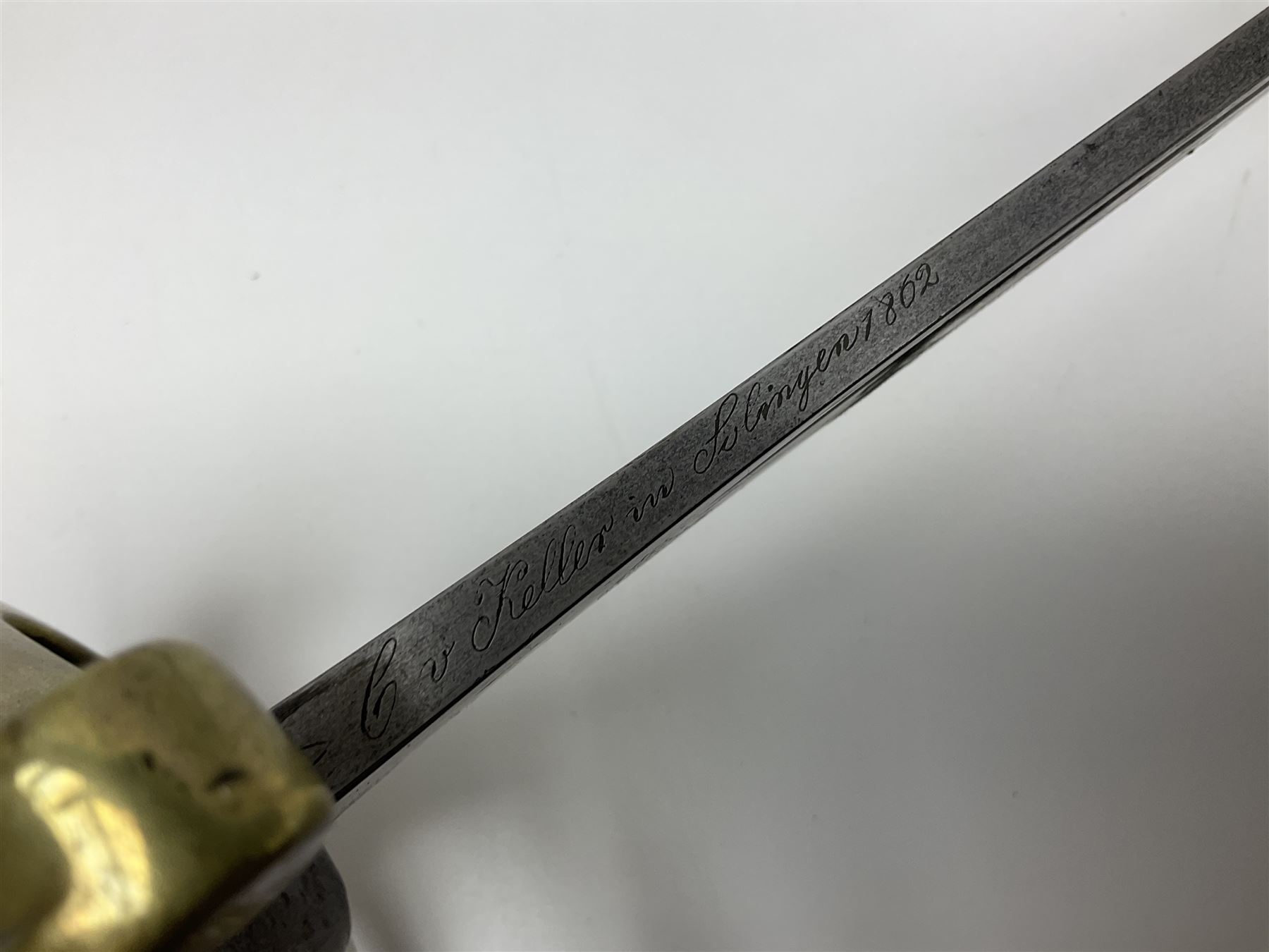 19th Century German (Saxony) Cavalry Sword, the 90.5cm single edge curved steel blade with narrow fuller to the back edge at each side, engraved with a crowned AR monogram and coat of arms, stamped with crowned AR, the back edge engraved C.v Keller im Solingen 1862, the brass half basket hilt with three flat curved bars, applied badge missing, marked G.R. 4, with ribbed leather covered grip and leather finger strap; in steel scabbard with two fixed suspension rings to one side and stamped G.R. II 118; L109.5cm overall