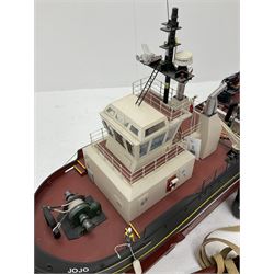 24-Volt radio controlled model of the American tug boat 'Jo-Jo' with full range of deck fittings, transmitter, remote control, receivers and two launching straps, displayed on wooden stand L103cm
