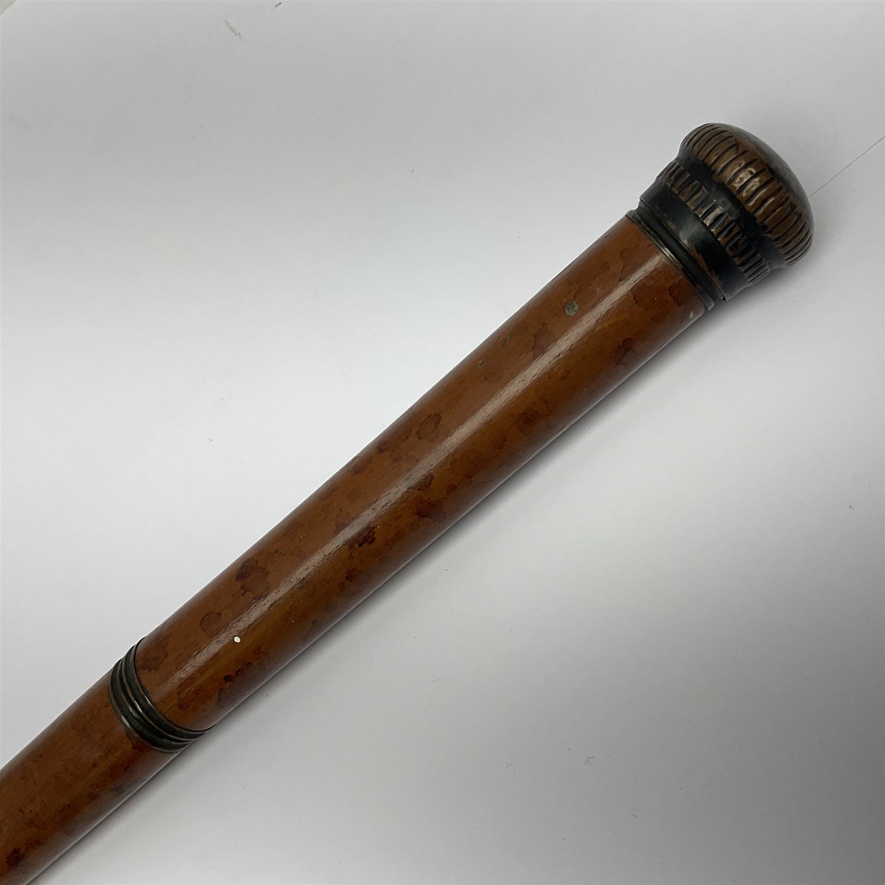 19th century malacca walking cane, the screw threaded domed cover opening to reveal vacant recess, above a further screw threaded opening revealing a removable glass vial with stopper, glass vial L41cm, cane L89.5cm