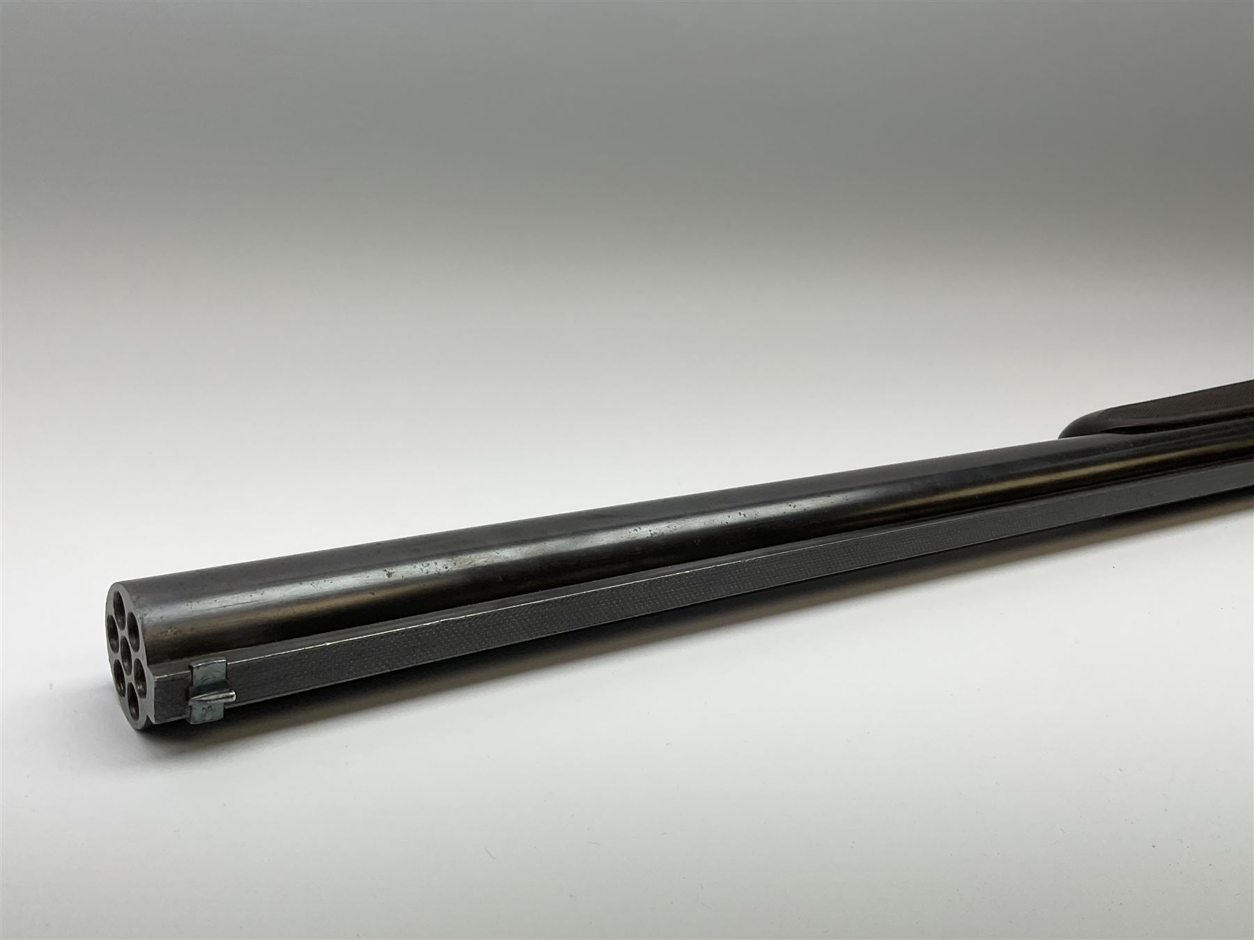 Rare Henry Pieper Liege seven-chambered solid barrel 297/30 calibre rim-fire volley gun with six barrels around a central seventh barrel drilled for simultaneous fire, built on a Remington type rolling block action, blued 62cm barrel with raised rib and twin rear leaf sights, case hardened action complete with loading plate for seven cartridges, walnut stock with chequered pistol grip and fore-end and inset 'silver' cartouche with two Chinese type characters, no.256PLN, L109cm overall