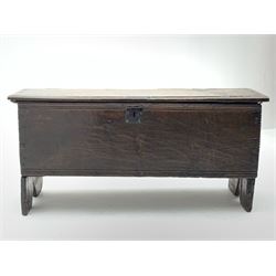 17th century boarded oak plank coffer, hinged lid with chip-carved edges and moulded decoration over matching front, shaped end supports, iron lock