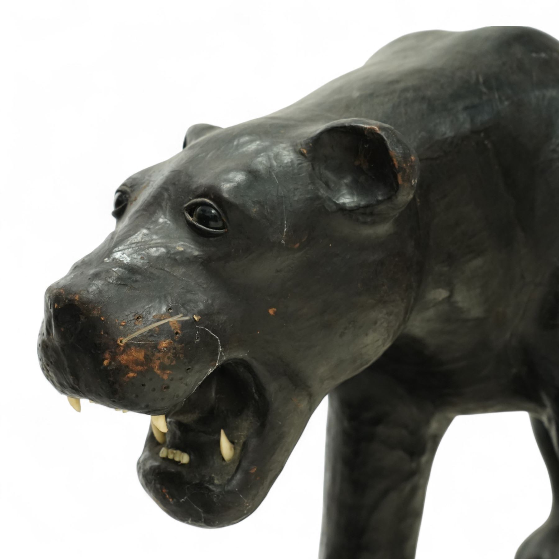 Early 20th century leather-covered decorative model of a Panther in a naturalistic stance, prowling forward with arched back, lowered head, and extended tail, open jaws revealing teeth and fangs with nylon whiskers