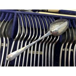 Late 19th/early 20th century composite canteen of silver flatware, contained within an early 20th century mahogany serpentine fronted case with twin drop carry handles, and hinged cover with boxwood stringing and central inlaid shell motif, above a single drawer with twin ring handles and Wellington style locking system, the cover and drawer opening to reveal plaque for Spink & Sons Ltd London, and fitted interior containing ivory handled knives, ivory handled carving set, and silver Hanoverian and Old English pattern cutlery, each with engraved monogram to terminal, hallmarked London, makers Spink & Son (John Marshall Spink), Goldsmiths & Silversmiths Co, and Chawner & Co (George William Adams), various dates ranging 1880-1923, gross weighable silver 92.59 ozt (2880 grams)