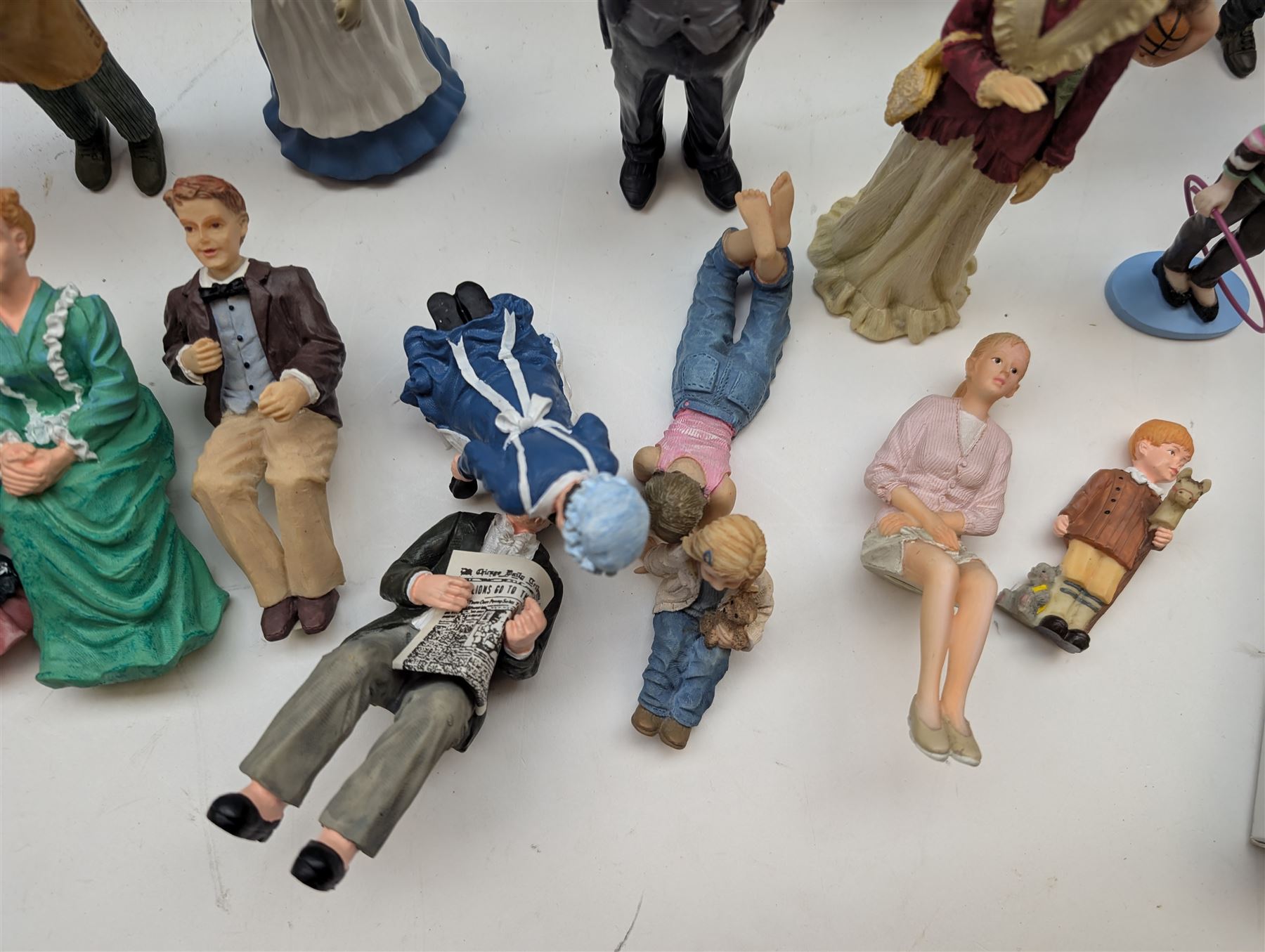 1:12 scale dolls house composite figures, including policeman, postman, maid, sitting and standing people in various styles of dress, etc