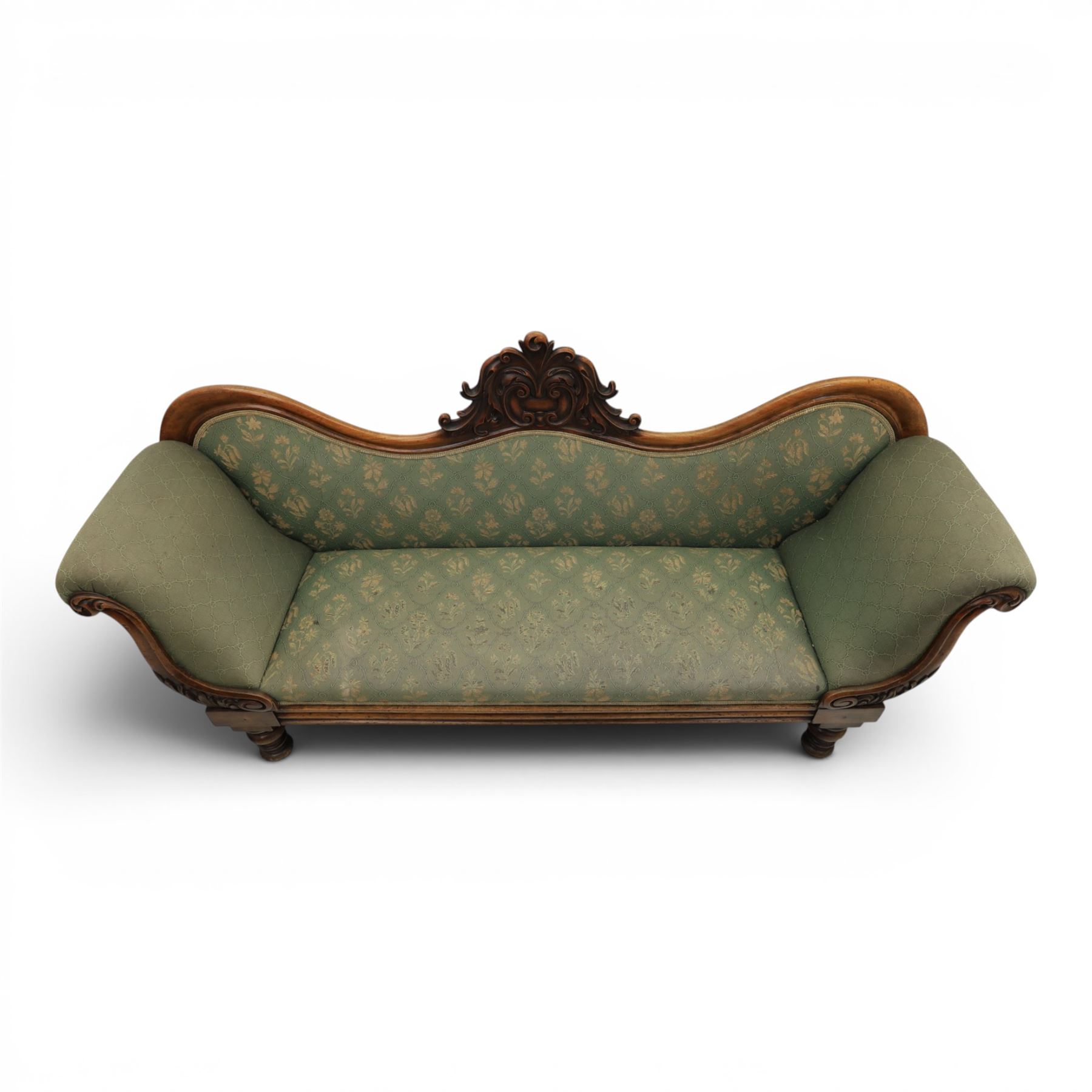 Victorian mahogany framed sofa, scroll arms with double camel back, green geometric upholstery, raised on turned supports