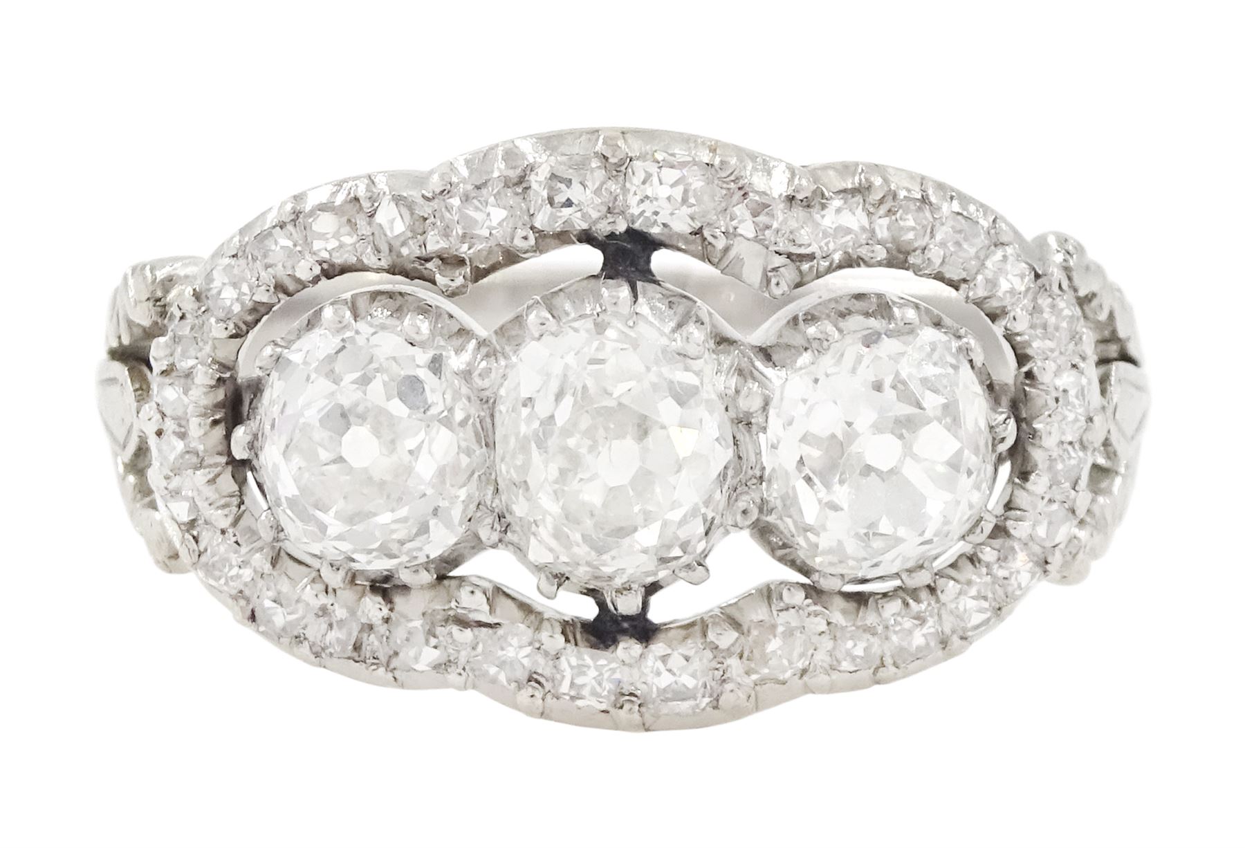 Late 19th / early 20th century platinum diamond ring, three old cut diamonds, in an openwork setting surrounded by further old cut diamonds, with pierced design shoulders, principal three diamonds total weight approx 1.45 carat, in a velvet and silk lined box by Selfridges