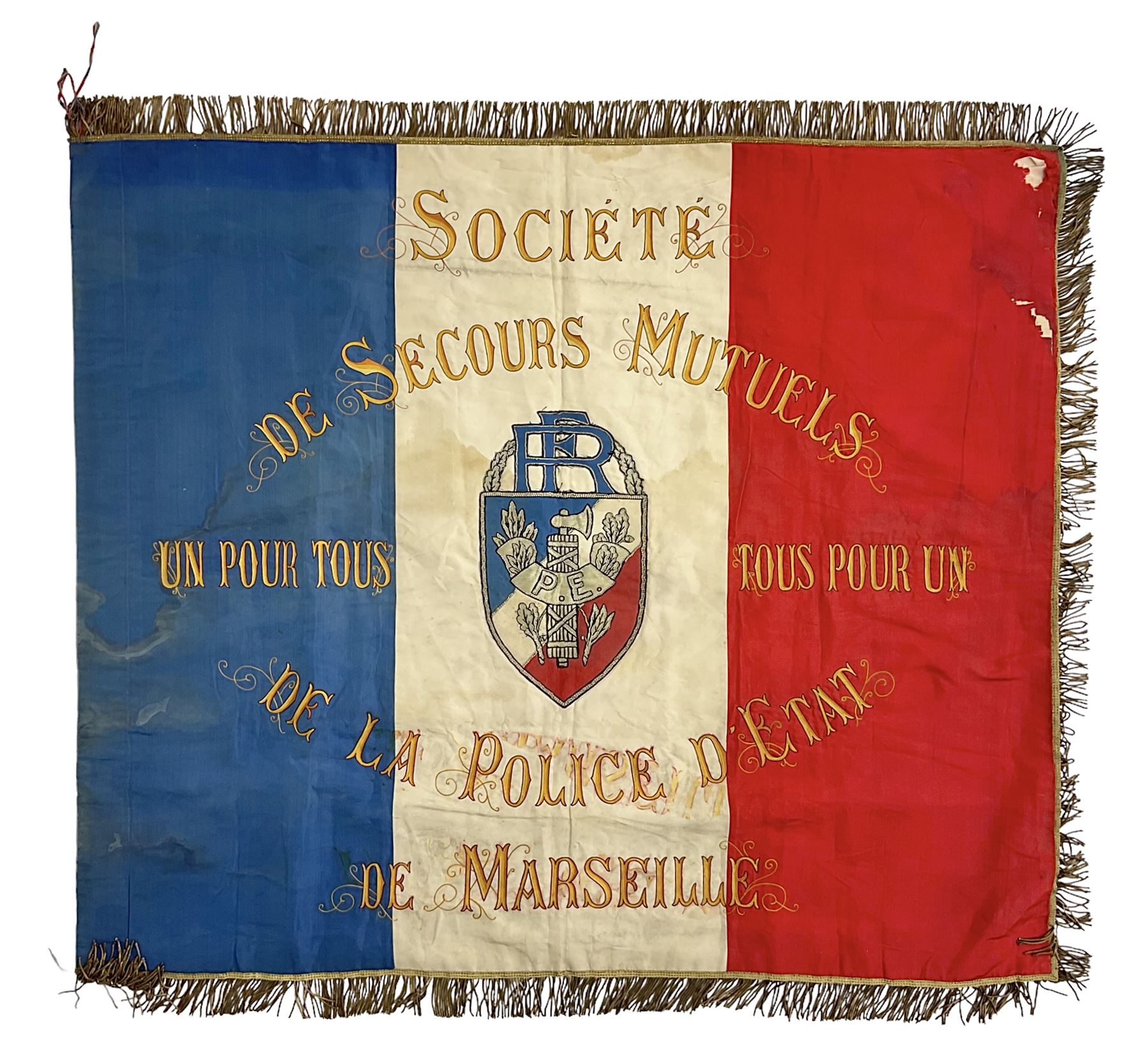French State Police banner as the tricolor flag embroidered with coloured and metallic thread 'Societe De Secours Mutuels Un Pour Tous Tous Pour Un De La Police D'Eteat De Marseille' to one side; plain flag verso; tassels to three sides 100 x 113cm