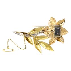 18ct gold diamond and ruby lily brooch, the platinum channel set diamond stem, amongst yellow gold polished and textured leaves, the milgrain set diamond and claw set ruby pistil amongst rose gold petals