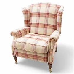 Laura Ashley - hardwood-framed wingback reclining armchair upholstered in checkered fabric, on turned and fluted front feet with brass cups and castors 