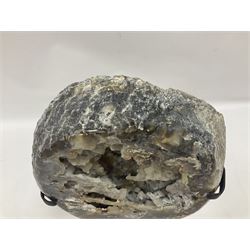 Large agate geode with quartz crystals to the centre, upon a metal stand, H35cm 