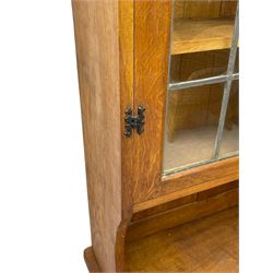 Gnomeman - adzed oak dresser, arcade carved cresting rail over two lead glazed doors, double cupboard below enclosed by two panelled doors, carved with gnome signature, by Thomas Whittaker, Little Beck 