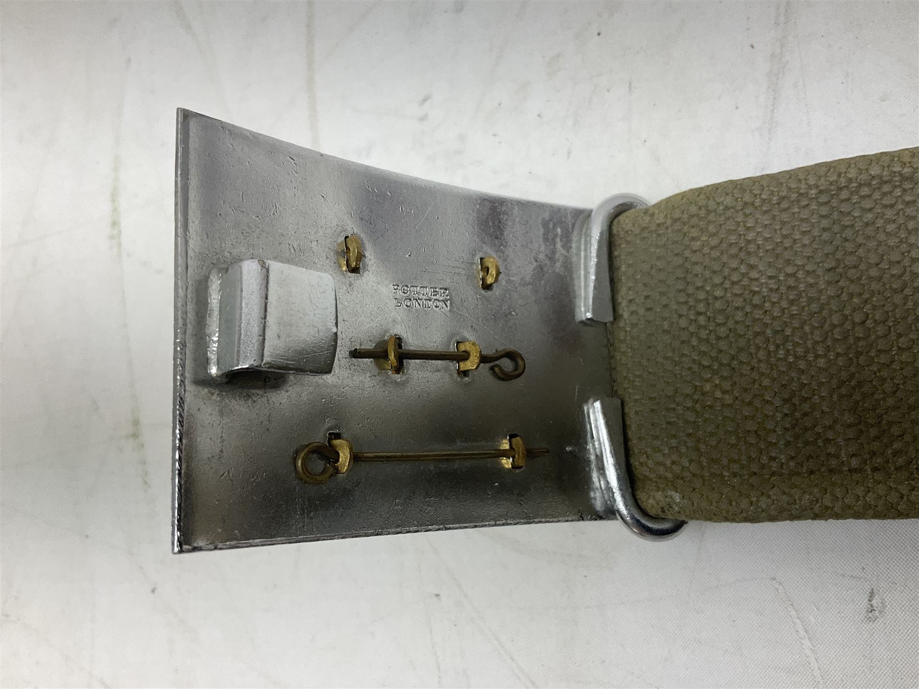 British Army Officers Sam Browne leather belt with shoulder strap; and webbing belt with Potter London Staybrite buckle for 19th Regiment of Foot (Green Howards) with various markings (2)