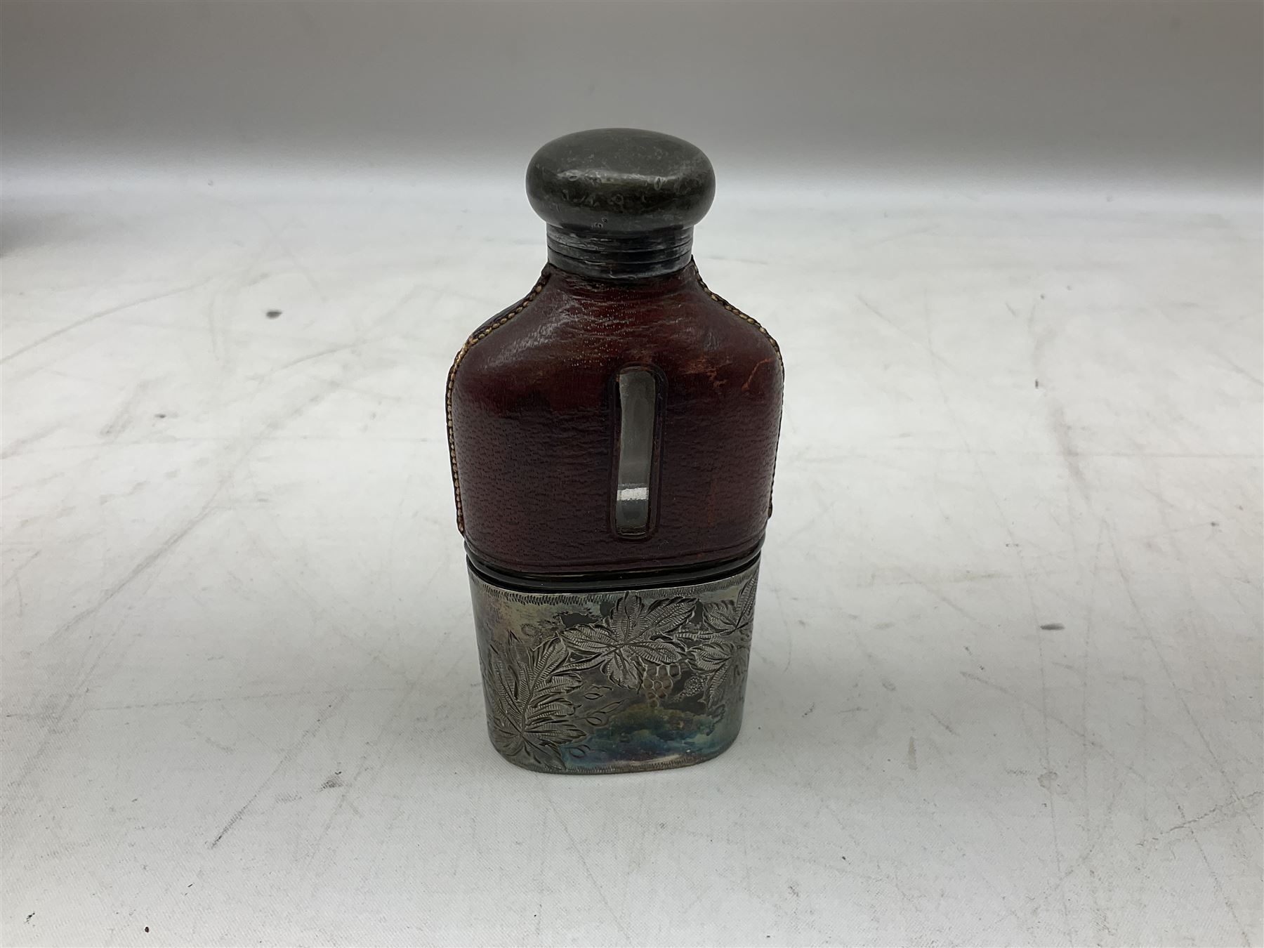 Cast metal nutcracker, in the form of a dog together with a pair of Swift Saratoga 8x40 binoculars in leather case and a hip flask, the glass flask covered in leather to the top with a detachable silver plated cup to base