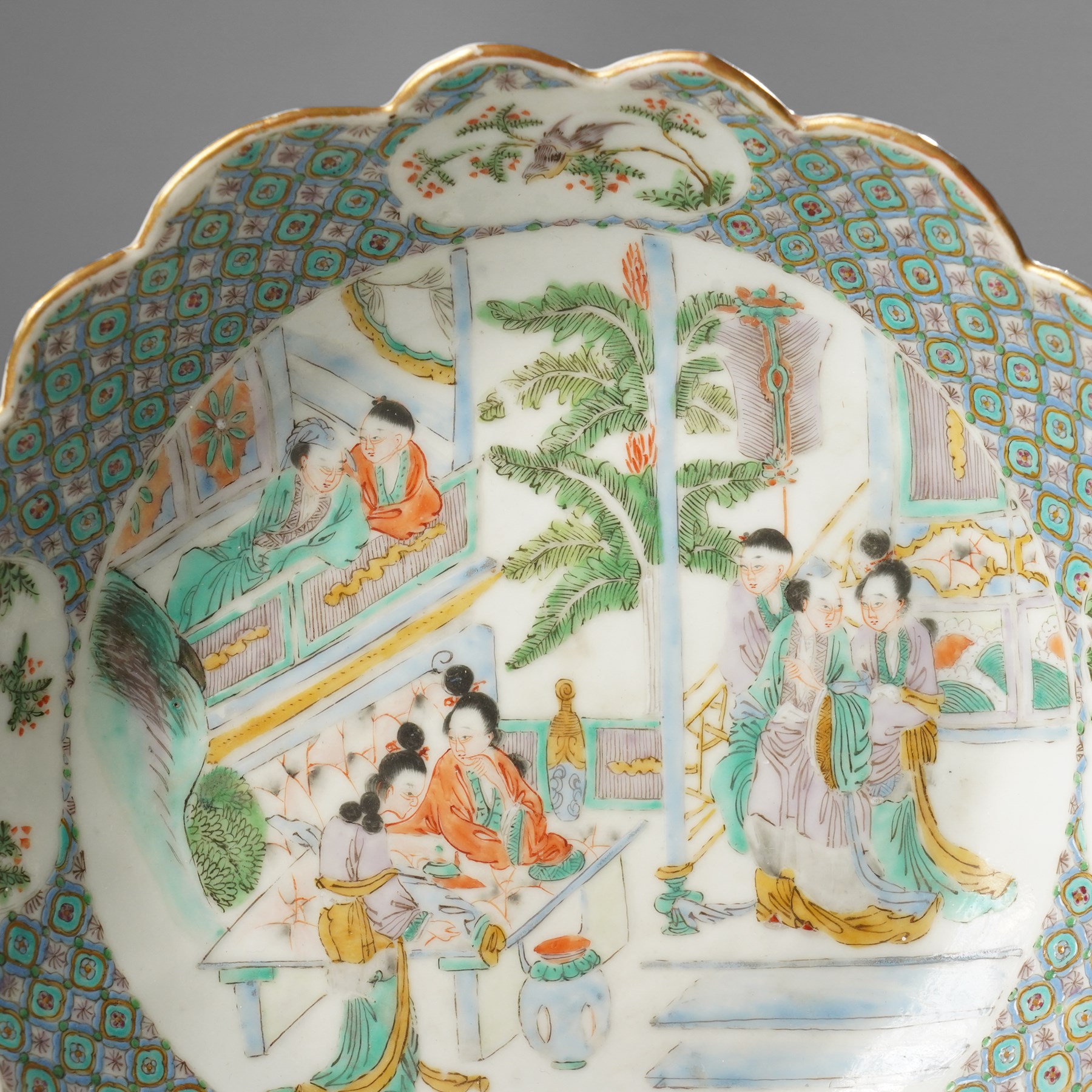 Chinese Kangxi period famille verte bowl, painted with seven figures in a pavilion interior, in Cantonese style border with foliate rim, the exterior painted with similar scenes, D24cm