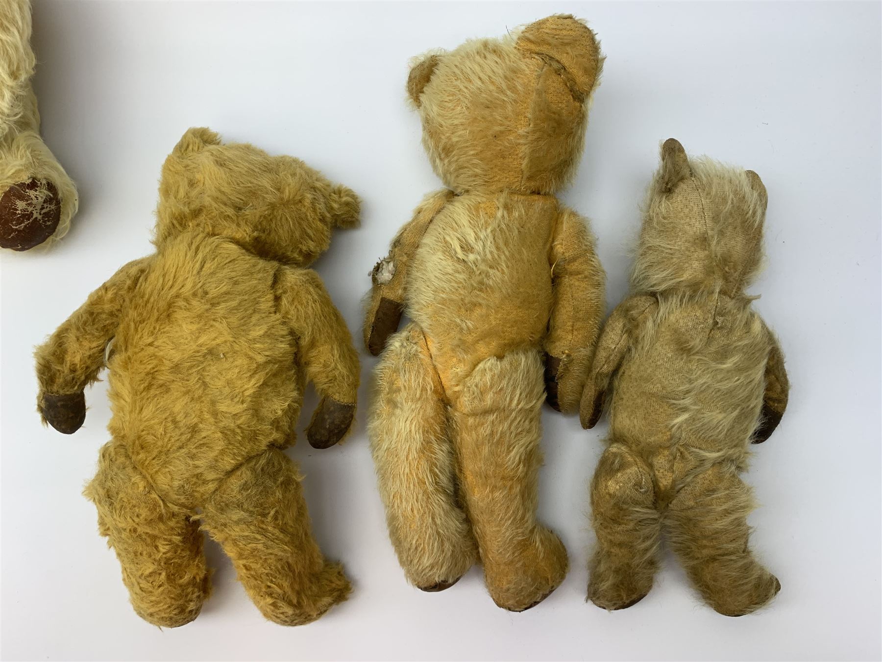 Five English teddy bears c1930s-50s comprising Chad Valley with swivel jointed head, glass eyes, vertically stitched nose and mouth and jointed limbs with rexine pads H16