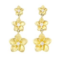 Pair of gold cubic zirconia flower head earrings, each stud with three graduating flowers,...