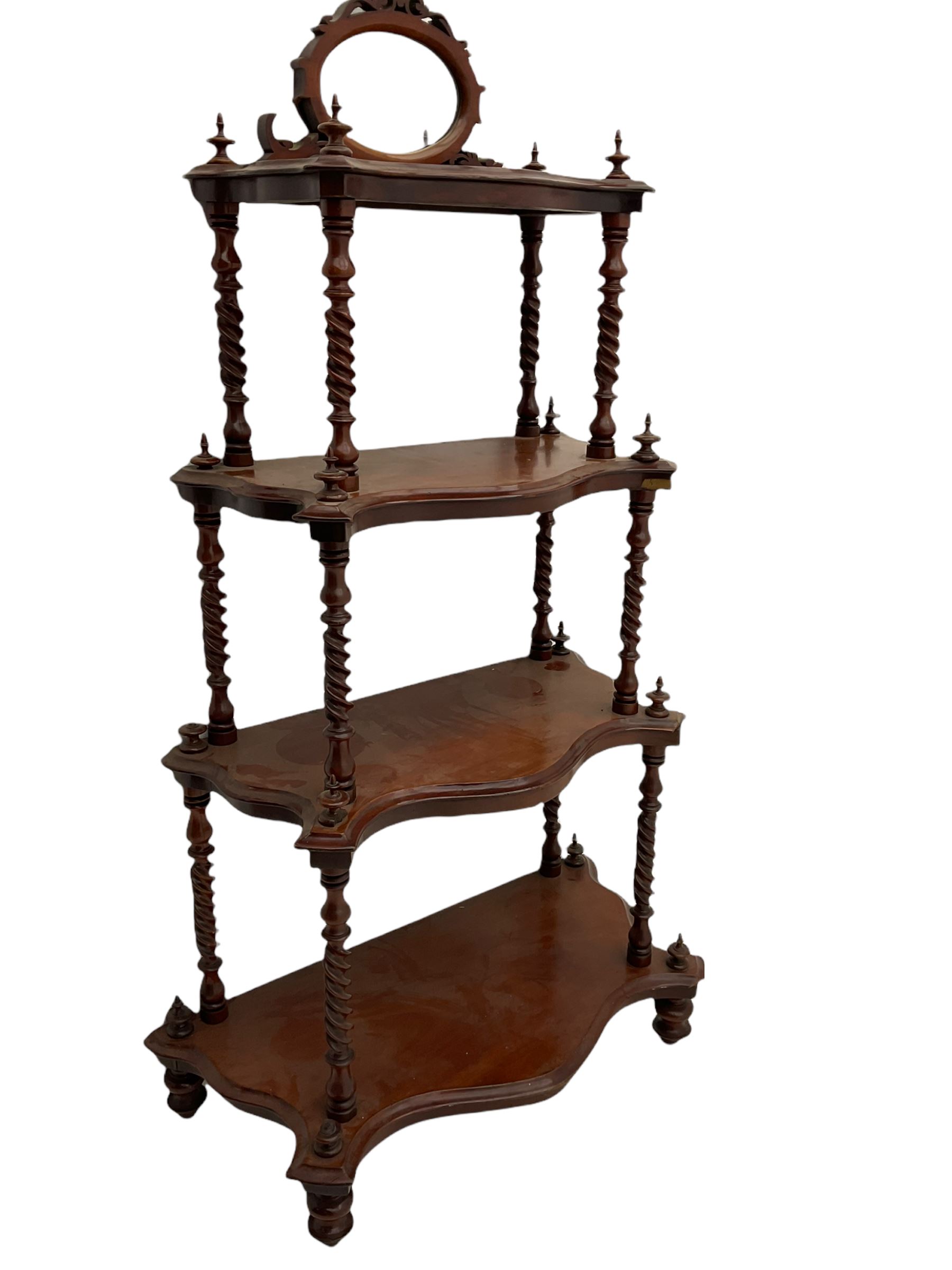 Victorian mahogany etagere, raised oval mirror in fretwork frame, four graduating shaped tiers, spiral turned supports