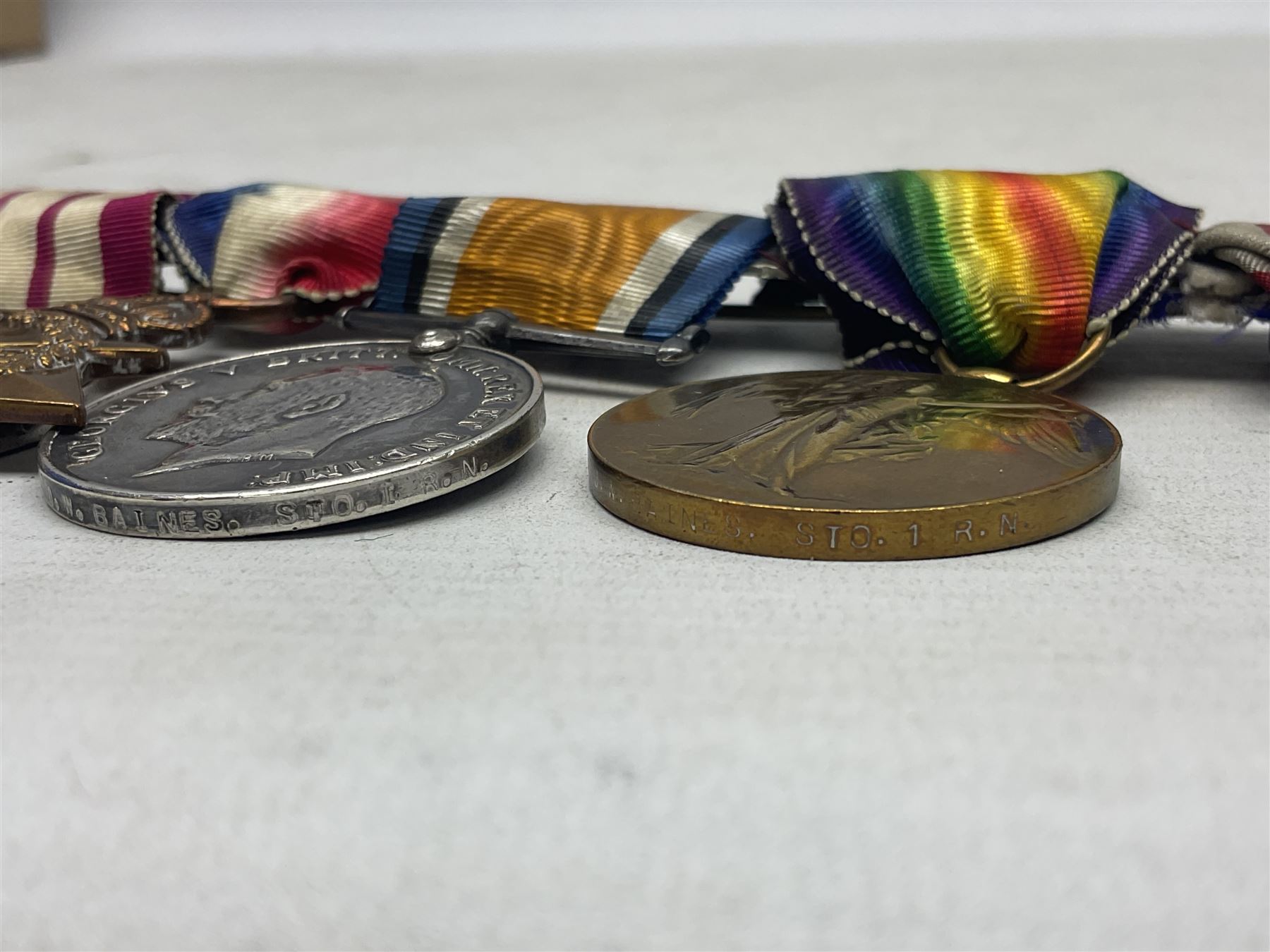 WW1 British Royal Navy Campaign and Royal Naval Fleet Reserve Long Service and Good Conduct group of five medals comprising British War Medal, 1914-15 Star and Victory Medal awarded to SS.113274 J.W. Baines Sto.1 R.N.; Naval general Service Medal to J.W. Baines Sto.1 N.B.; and Royal Fleet Reserve Long Service and Good Conduct Medal to SS.113274 (Dev. B.7397) J.W. Baines Sto.1 R.F.R.; all with ribbons